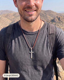 Man wearing the silver Cross & Sword, X-Large 60mm, on a leather necklace