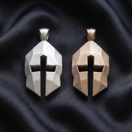 Silver and bronze Cross & Helm pendants side by side on black satin