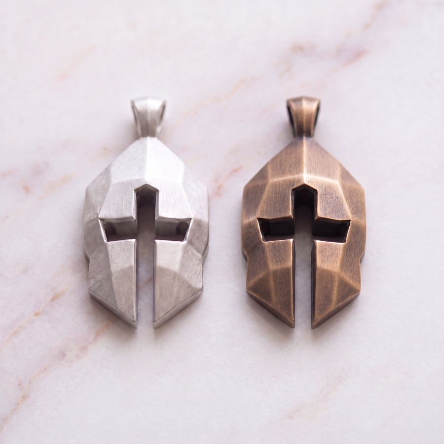 Women's Cross & Helm pendants in silver and bronze on white marble