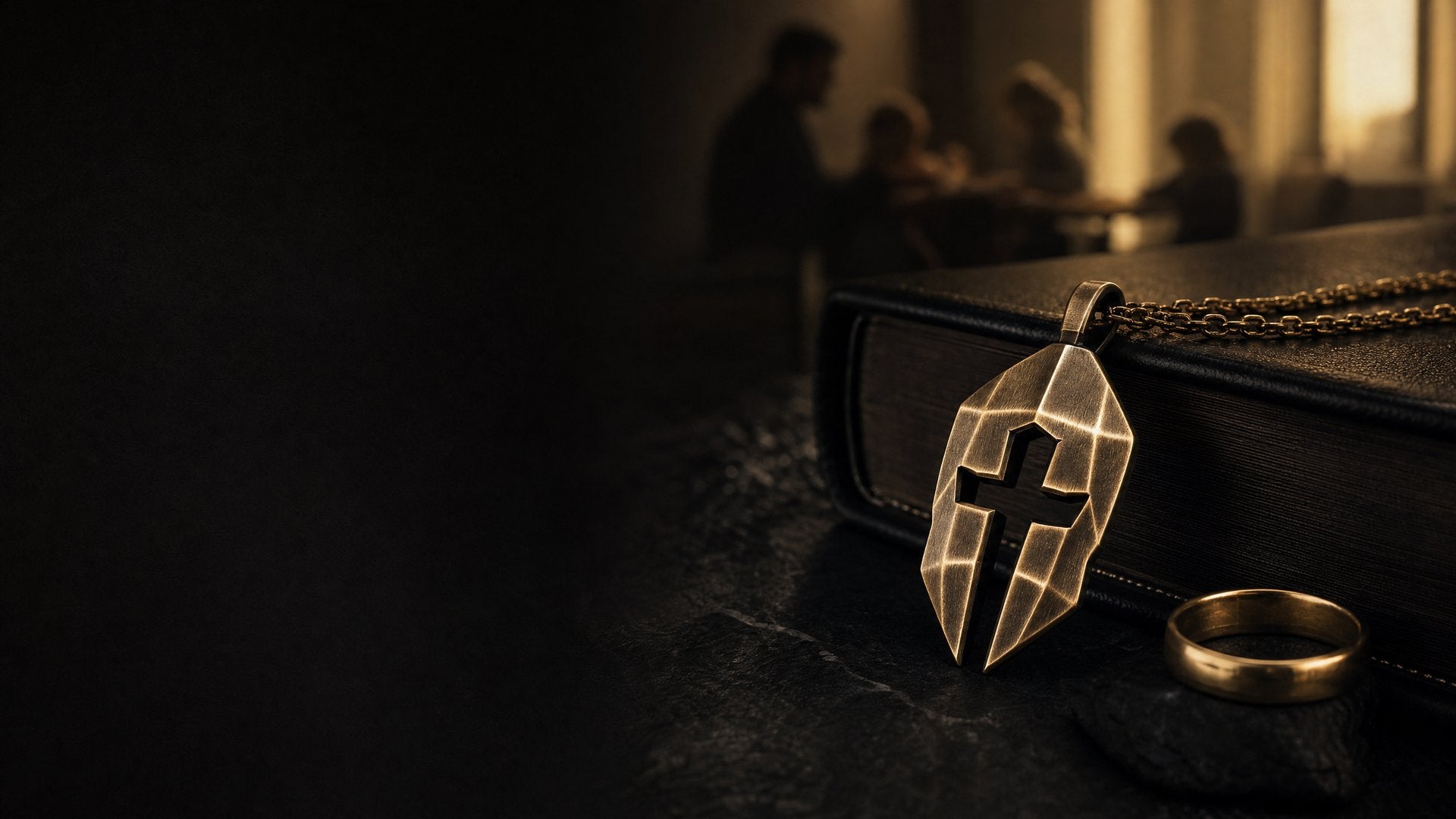 Cross & Helm pendant beside a wedding ring and Bible as a reminder of faith, marriage, and fatherhood
