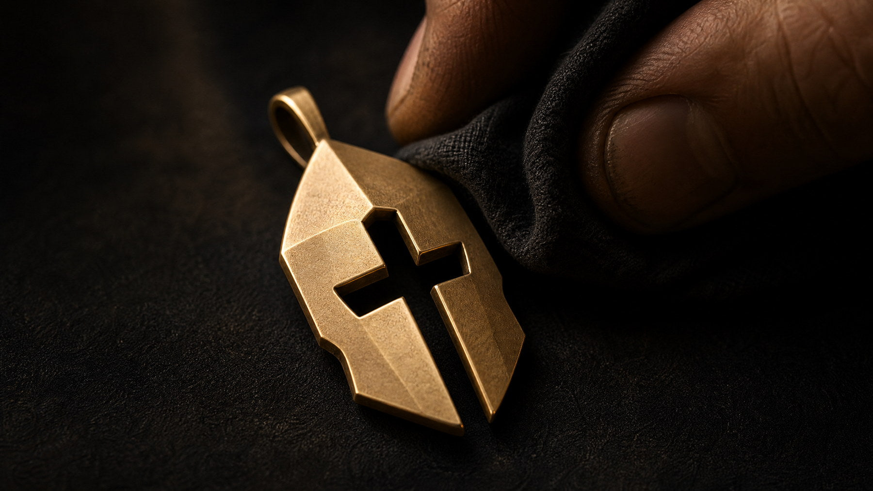 Extreme macro detail of a Cross and Helm pendant showing brushed texture cross cutout and beveled geometry