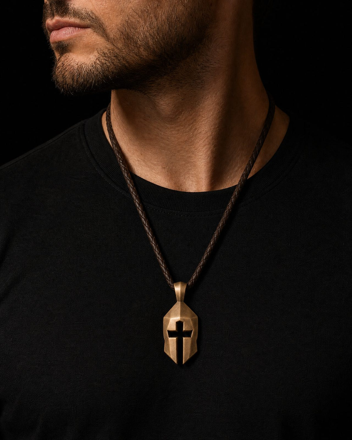 Cross and Helm leather necklace worn in a refined low-light setting