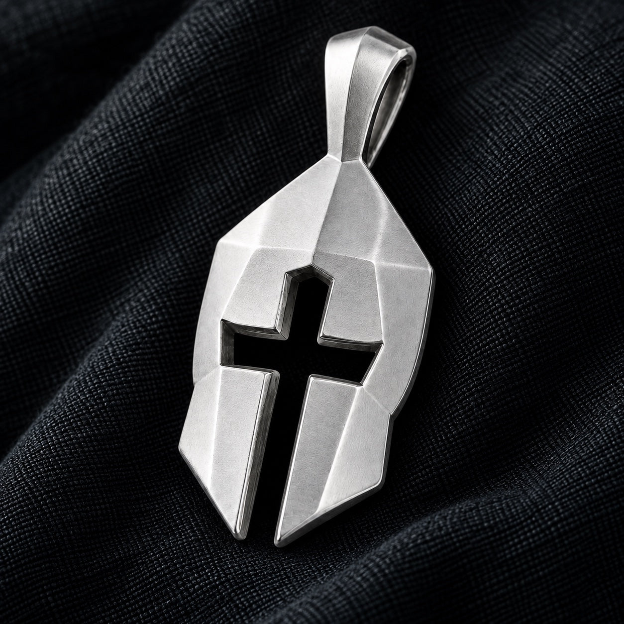 Silver Cross & Helm pendant on charcoal linen, showing the cross at the center